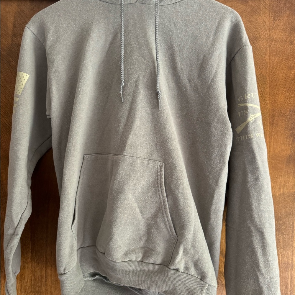 Grey mens hoodie with red white and blue eagle wings on the back.